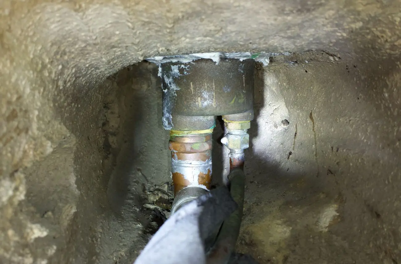 Constrained workspace and tight plumbing clearances beneath the fountain bowl.